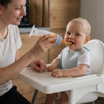 Mother feeding her baby with the Nomly squeeze spoon feeder